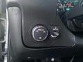 Dashboard controls of a 2017 Chevrolet Express featuring a dial for headlight settings and a switch for fog lights