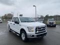 A 2017 Ford F-150 in white with chrome accents and a crew cab parked at an outdoor location