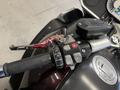 Close-up of the handlebar controls on a 2013 BMW K1600GTL featuring various buttons levers and a throttle grip