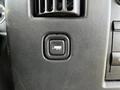 Black button with a truck icon on a textured dashboard of a 2015 Chevrolet Express van