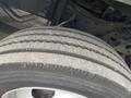 A close-up of a tire from a 2011 Ford Utilimaster Food Truck showing worn tread patterns and dirt accumulation on the surface