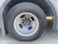 Close-up of a tire and rim from a 2017 Chevrolet Express showing a steel wheel with lug nuts and a treaded tire