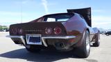 A 1971 Chevrolet Corvette Stingray with a brown exterior and distinctive rear design featuring round tail lights and a raised hood