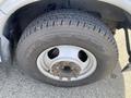 Close-up of a tire on a 2017 Chevrolet Express with visible treads and a silver steel wheel showing lug nuts