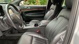 Interior view of a 2013 Lincoln MKT featuring black leather seats and a center console with cup holders and controls