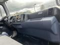 Interior dashboard of a 2008 Hino 268 showing the steering wheel control panel and gear shift with various buttons and compartments visible