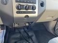 The interior dashboard of a 2013 Ford Expedition with climate control knobs and a space for a radio or stereo unit