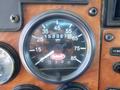 A speedometer from a 2008 Peterbilt 335 displaying a speed of 65 MPH with an odometer reading of 153327 miles