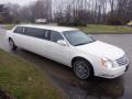 A 2008 white Cadillac limousine with chrome wheels and elongated body showcasing a sleek design and elegant features