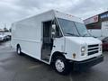 A 2005 Freightliner MT45 Chassis in white with an open driver's door and a boxy design typical of delivery trucks