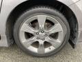 Close-up of the alloy wheel of a 2013 Toyota Sienna featuring a silver finish and visible brake components