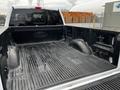 A 2017 Ford F-150 truck bed with a textured rubber mat and visible wear marks