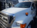 A white 2007 Ford F-650 with a prominent chrome grille and large headlights parked at an angle