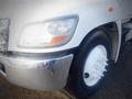 Close-up of the front wheel and chrome bumper of a 2013 Hino 308 truck showing the wheel rim and five white bolt covers