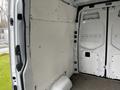 Interior of a 2021 Mercedes-Benz Sprinter van with a bare metal floor and unadorned walls lined with white panels