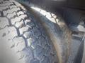 Close-up of a heavy-duty tire showing deep treads and wear on a 2006 Ford F-650 truck