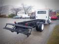 A 2006 International 4300 chassis cab with a flatbed, showing the rear view and dual wheels without a cargo box