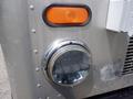 Close-up of a chrome headlight and amber turn signal on the front of a 2007 Morgan Olson Workhorse W42 vehicle