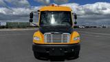 A yellow and black 2014 Freightliner Thomas Bus Diesel facing forward with prominent headlights and a silver grill