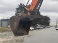 A 2006 Hitachi ZX200LC excavator bucket positioned for digging