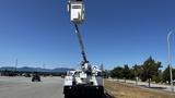 A white 2011 Ford F-450 SD bucket truck with an extended lifting arm and bucket for aerial work