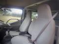 Interior of a 2003 Toyota Toyoace showing two cloth-covered front seats and a gear shift in a clean cabin space