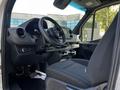 Interior view of a 2022 Mercedes-Benz Sprinter showcasing the driver's seat dashboard and center console with cup holders