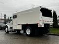 A 2007 Freightliner M2 106 truck with a white box-shaped body and a rear open cargo area