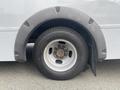 A close-up view of the rear wheel and fender of a 2017 Chevrolet Express showing the tire tread and rim details