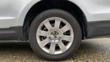 A close-up view of a silver 2013 Lincoln MKT tire and wheel with a circular rim and prominent Lincoln emblem in the center