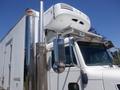 A white 2008 Peterbilt 335 truck with a silver exhaust pipe and a refrigerated unit mounted on top