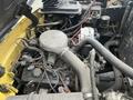 Close-up of the engine compartment of a 2000 Hyster 120 showcasing various components including hoses wires and an air intake manifold