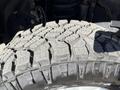 Close-up of a rugged tire tread on a 2019 Ford F-350 SD showcasing deep grooves and textured surface designed for off-road traction