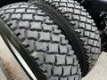 Close-up of the tires of a 2014 Kenworth T370 showing deep treads designed for traction and durability