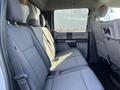 A 2019 Ford F-350 SD features a spacious rear seating area with gray fabric upholstery and three seats arranged in a row