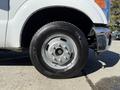 Close-up of the wheel and tire of a 2016 Ford F-350 SD showing a silver rim with six bolt holes and a Michelin tire