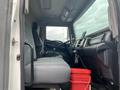 Interior view of a 2018 Hino 308 showing the driver's seat dashboard and a red bucket on the floor