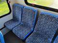 A 2017 Chevrolet Express interior with three blue patterned seats arranged in a row