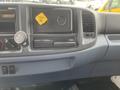 Interior view of a 2008 Hino Conventional Cab showing the dashboard with various controls gauges and a storage compartment