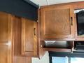 Interior cabinets of a 2012 Ford Econoline with wooden finishes and multiple storage spaces