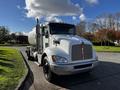 A white 2013 Kenworth T370 truck with a silver tanker attached and prominent front grille detailing