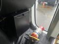 A 2017 Chevrolet Express interior showing a black equipment storage box and a red fire extinguisher on the floor