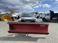 A 2010 Ford F-550 truck equipped with a red Western snow plow mounted in the front
