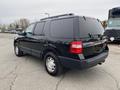 A black 2017 Ford Expedition SUV viewed from the rear angle showcasing its sleek design and large size