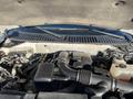 A 2013 Ford Expedition engine compartment showing the engine components including air intake hose battery and various engine parts
