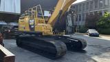 A 2018 Cat 326F Track excavator with a yellow body and black tracks positioned on a flat surface