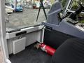 Inside a 2007 Tennant Sentinel cleaning machine with a visible dashboard control panel and a fire extinguisher mounted on the floor