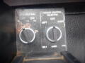 Control panel with two rotary knobs labeled Packer Control Select and a neutral switch showing Off and On positions