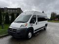 A 2016 RAM Promaster van with a white exterior and dark tinted windows parked on a concrete surface