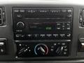A dashboard display of a 2008 Ford F-750 featuring a radio and climate control knobs